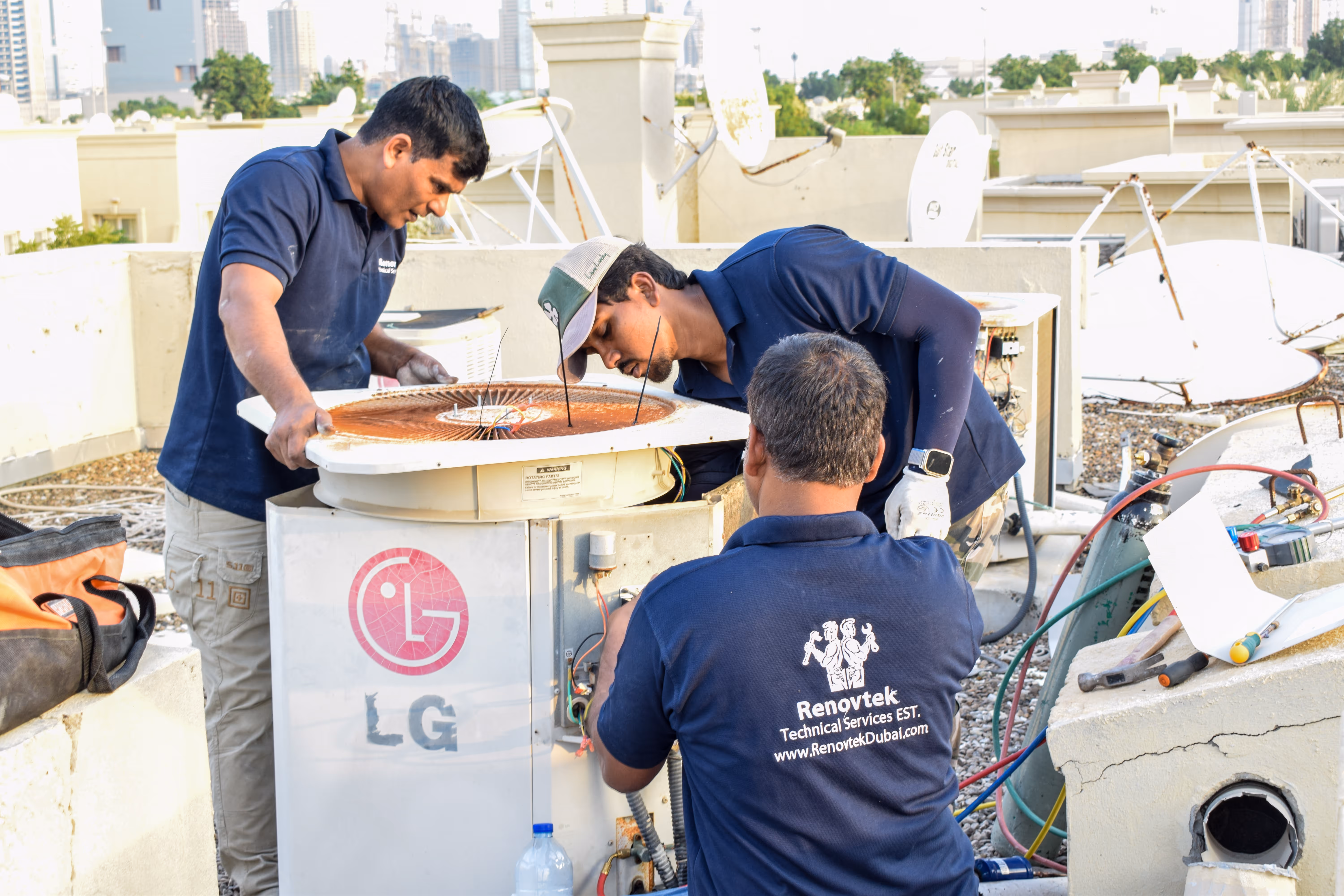 Men woring on an AC unit on the roof