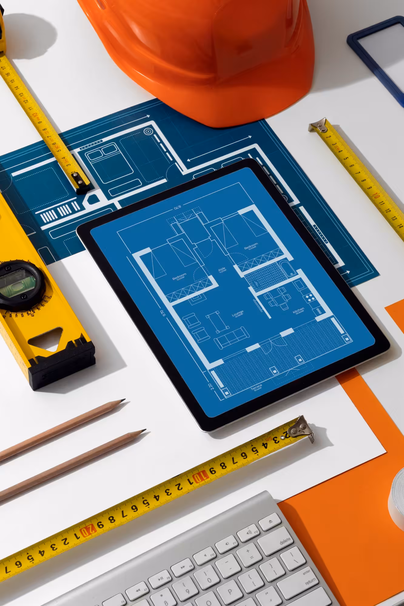 Blueprints and design tools on a wooden table.