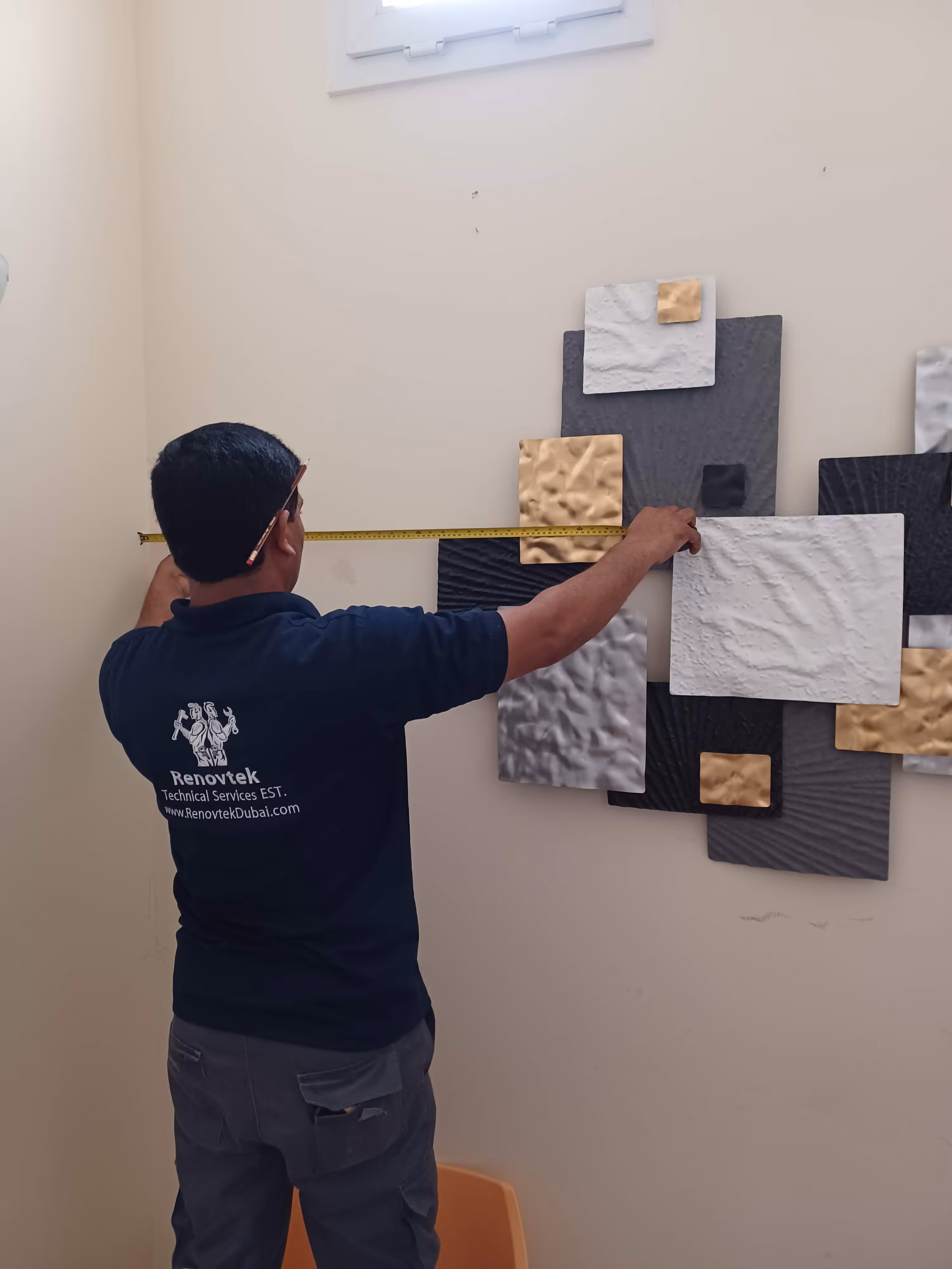 a technician measure distance of the frame to the wall