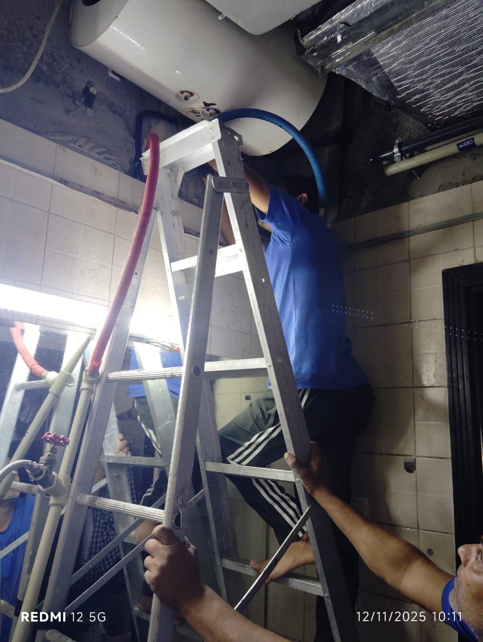 technician repairing a water heater in Dubai